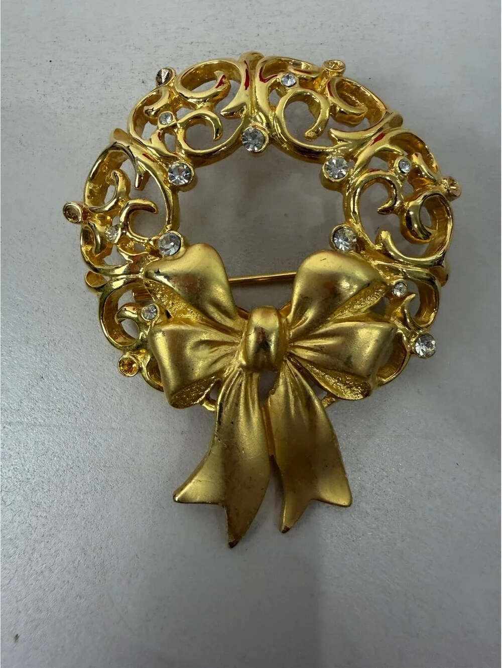 Vintage JJ Gold Tone Wreath Brooch with Bow and Rhinestones